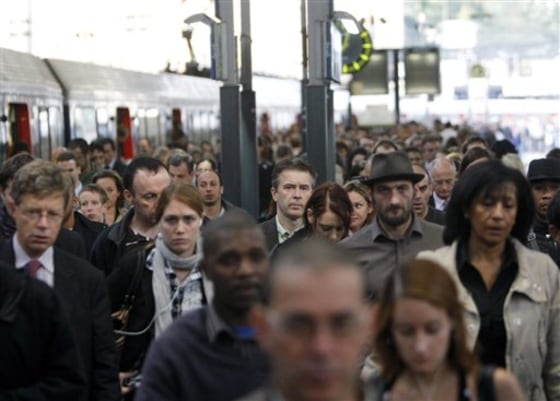 Passengers arrive at Saint Lazare train station on Thursday in Paris, France. Protesters are counting on people power to pressure the government to back down on its plan to up the retirement age from 60 to 62, with a second round of September strikes expected to hobble public transport, air traffic and schools across France. 